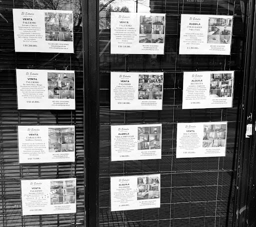 Property listings posted on window in Palermo, Buenos Aires.